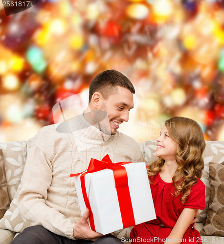 Image of smiling father and daughter looking at each other