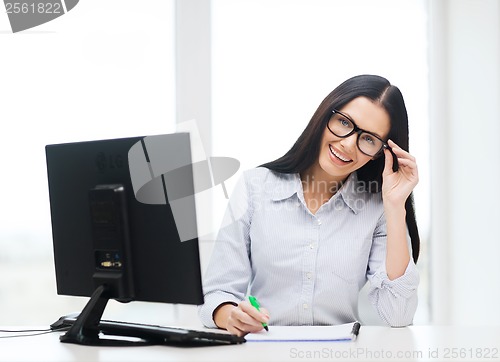 Image of smiling businesswoman or student with eyeglasses