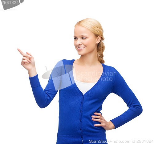 Image of smiling woman in pointing her finger