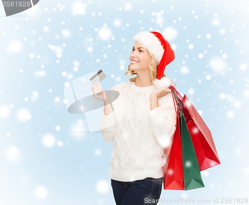 Image of woman with shopping bags and credit card