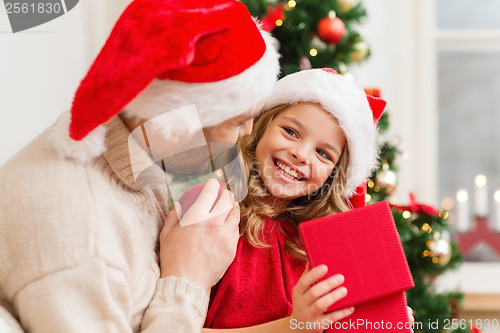 Image of smiling father and daughter opening gift box