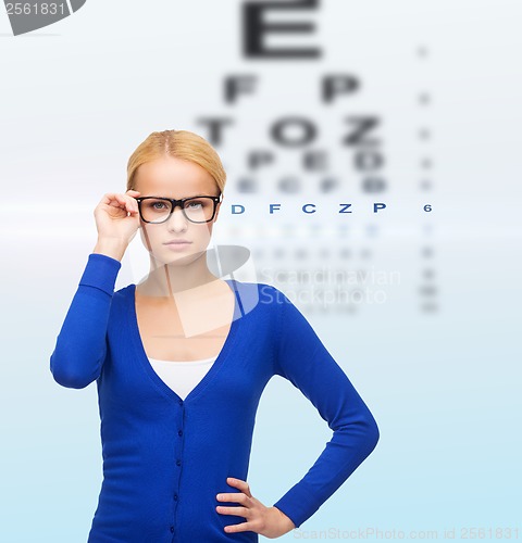 Image of smiling woman in casual clothes wearing eyeglasses