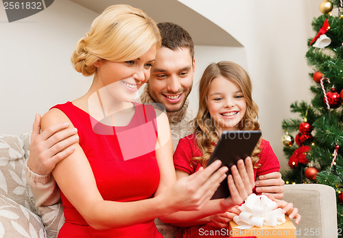 Image of smiling family with tablet pc