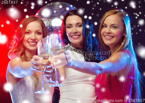 Image of three smiling women with champagne glasses