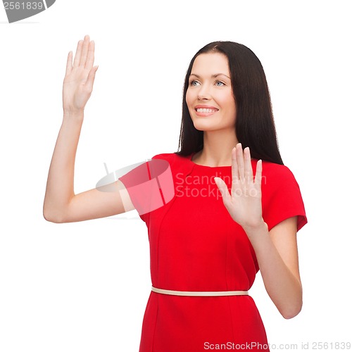 Image of woman in red dress working with virtual screen