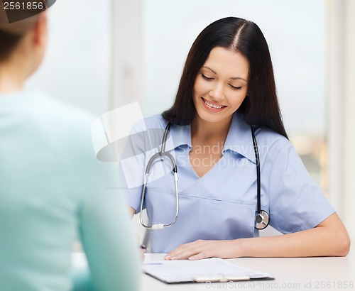 Image of smiling doctor or nurse with patient