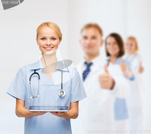 Image of smiling female doctor or nurse with tablet pc