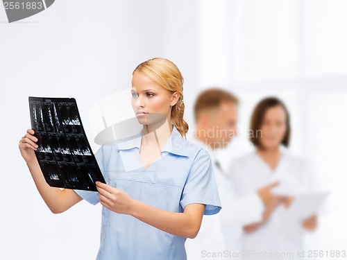 Image of serious doctor or nurse looking at x-ray