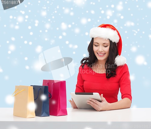 Image of woman with gift box and tablet pc computer