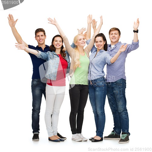 Image of group of smiling students waving hands