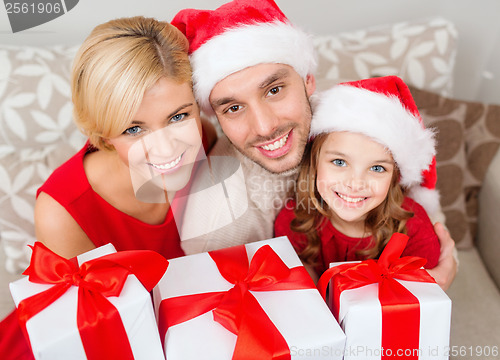 Image of smiling family holding many gift boxes