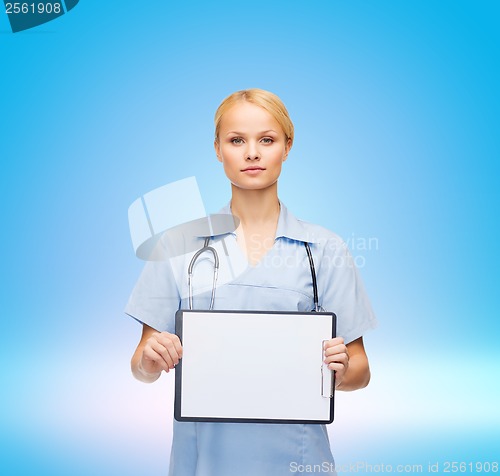 Image of smiling female doctor or nurse with sclipboard