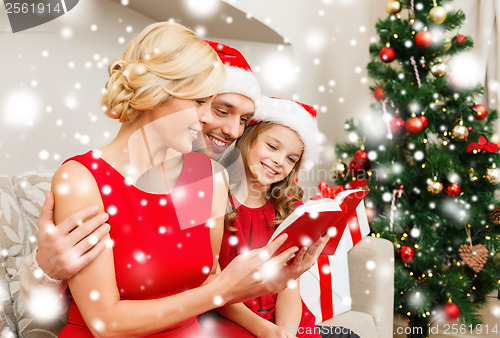 Image of smiling family reading book