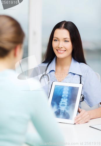 Image of doctor or nurse showing x-ray with tablet pc