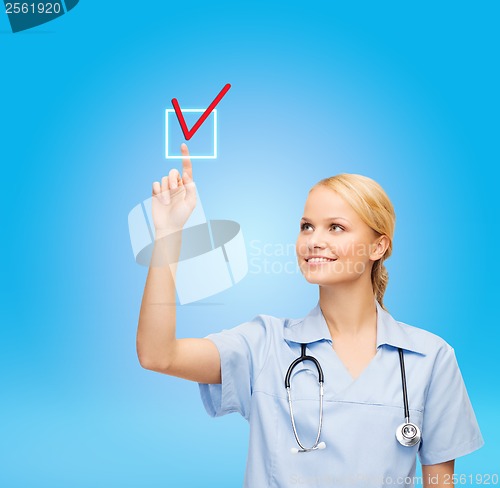 Image of smiling doctor or nurse selecting