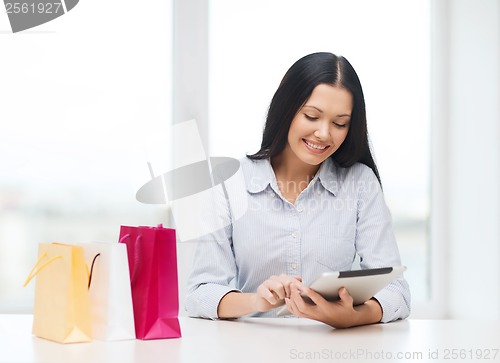 Image of smiling woman with blank screen tablet pc