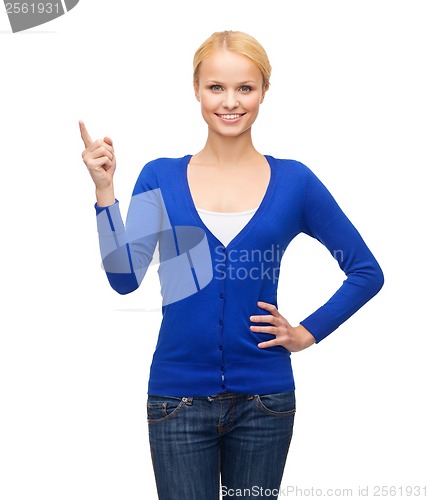 Image of smiling woman pointing her finger up