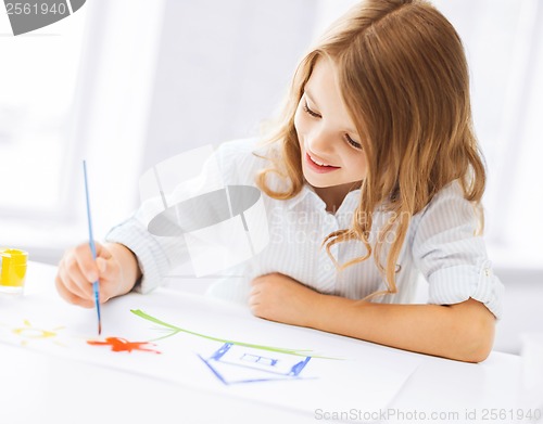 Image of little girl painting picture