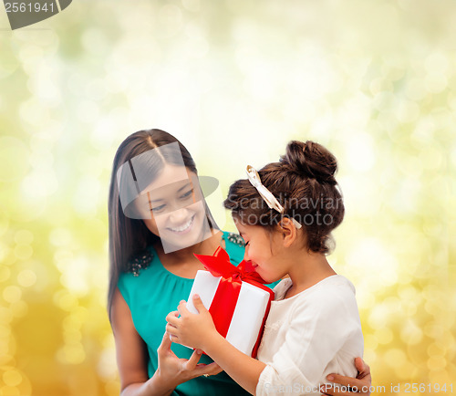 Image of happy mother and child girl with gift box