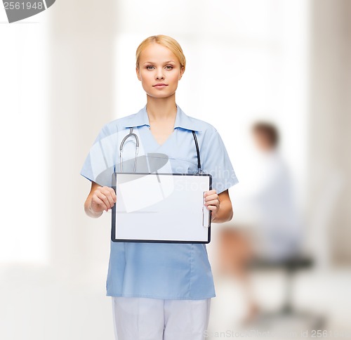 Image of smiling female doctor or nurse with sclipboard