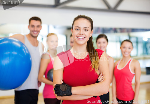 Image of woman standing in front of the group in gym