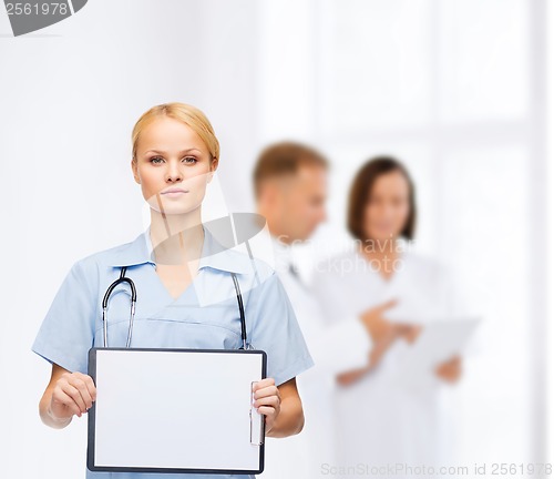 Image of smiling female doctor or nurse with sclipboard