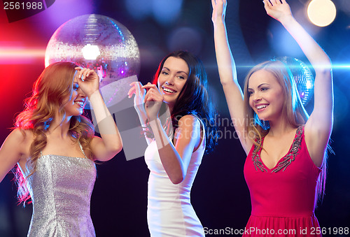 Image of three smiling women dancing in the club