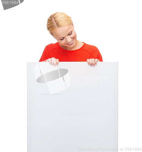 Image of smiling woman in sweater with blank white board