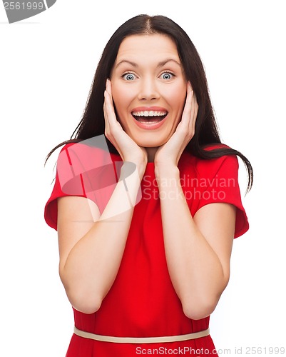 Image of amazed laughing young woman in red dress