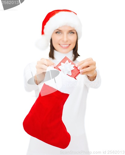 Image of smiling woman with small giftbox and stocking