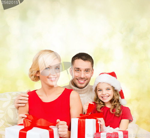 Image of smiling family holding many gift boxes