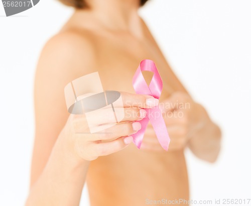 Image of hand holding pink breast cancer awareness ribbon