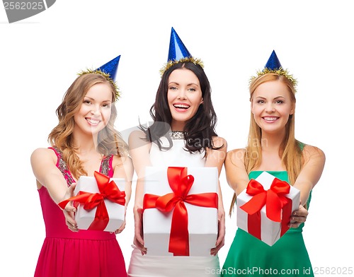 Image of three smiling women in blue hats with gift boxes