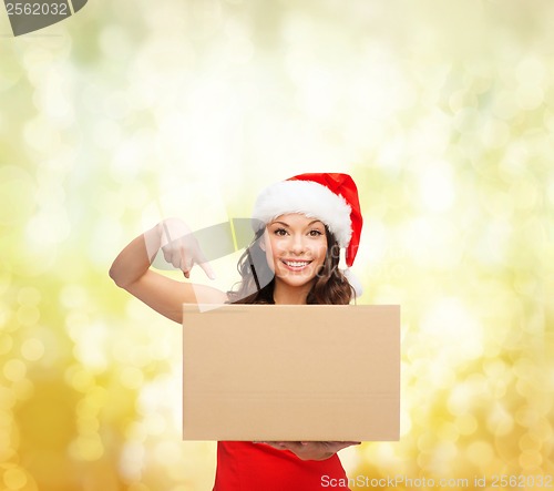 Image of smiling woman in santa helper hat with parcel box