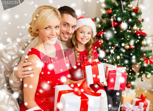 Image of smiling family holding many gift boxes