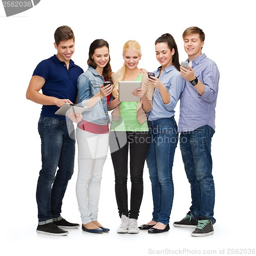 Image of smiling students using smartphones and tablet pc