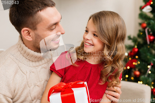 Image of smiling father and daughter looking at each other