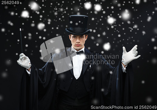 Image of magician in top hat with magic wand showing trick