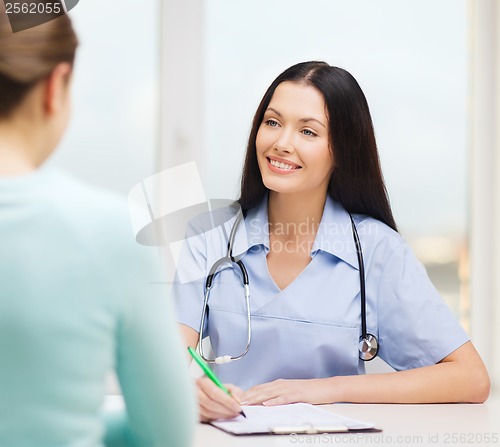 Image of smiling doctor or nurse with patient