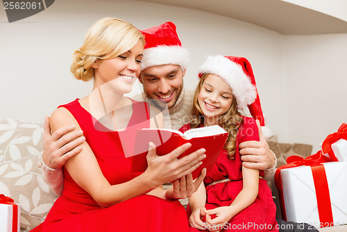 Image of smiling family reading book