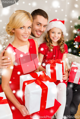 Image of smiling family holding many gift boxes