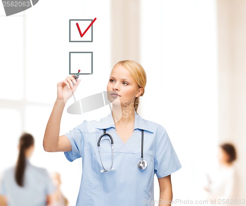 Image of doctor or nurse drawning checkmark into checkbox