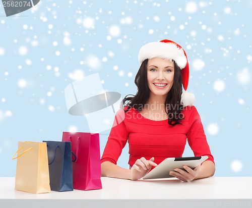 Image of woman with gift box and tablet pc computer