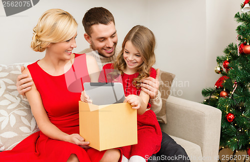 Image of smiling family with tablet pc