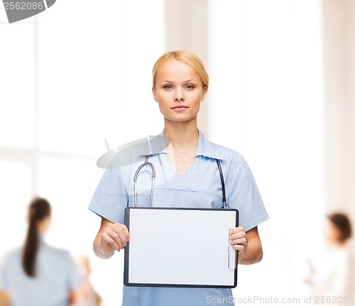 Image of smiling female doctor or nurse with sclipboard