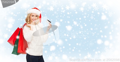 Image of woman with shopping bags and credit card