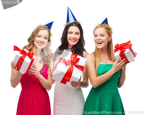 Image of three smiling women in blue hats with gift boxes