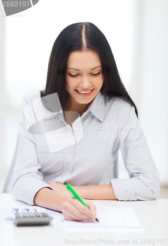 Image of businesswoman or student working with calculator