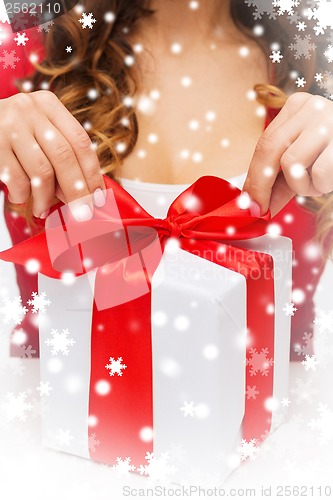 Image of woman hands opening gift boxes