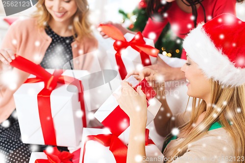 Image of three women holding many gift boxes